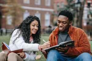 two students sitting on campud