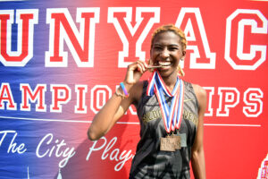 Kenia Irish-Bramble finally gets a moment of rest to enjoy her earned spoils at the CUNYAC Championships on May 3, 2025. (Nick Masuda/Office of Communications)