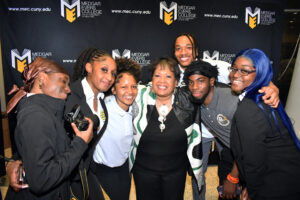 Reena Evers-Everette enjoys the company of Brooklyn Recovery Corps students during the "Daughters of the Legacy" event in April. In this photo, a pair of seniors — Awa Diallo (far left) and Sheray Goday (far right) — take a moment to engage with the social justice icon. (Nick Masuda/Office of Communications)