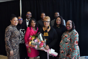 President Patricia Ramsey (with flowers) poses with Marsha Escayg (left) and the rest of her Executive Cabinet. (Amunet Jones/Student in Office of Communications)