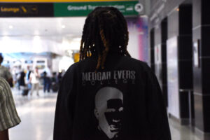Eternity Council walks through the airport wearing a tribute jacket to Medgar Wiley Evers. (Maritza Argueta/Intern, Office of Communications)