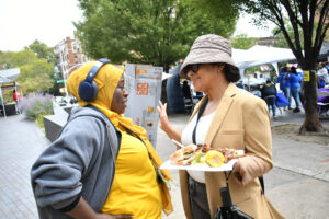 Amani Reece, the director of Student Life, chats with Lisa Evelyn, the director of the Women's Center, during Club Fair. (Nick Masuda/Office of Communications)