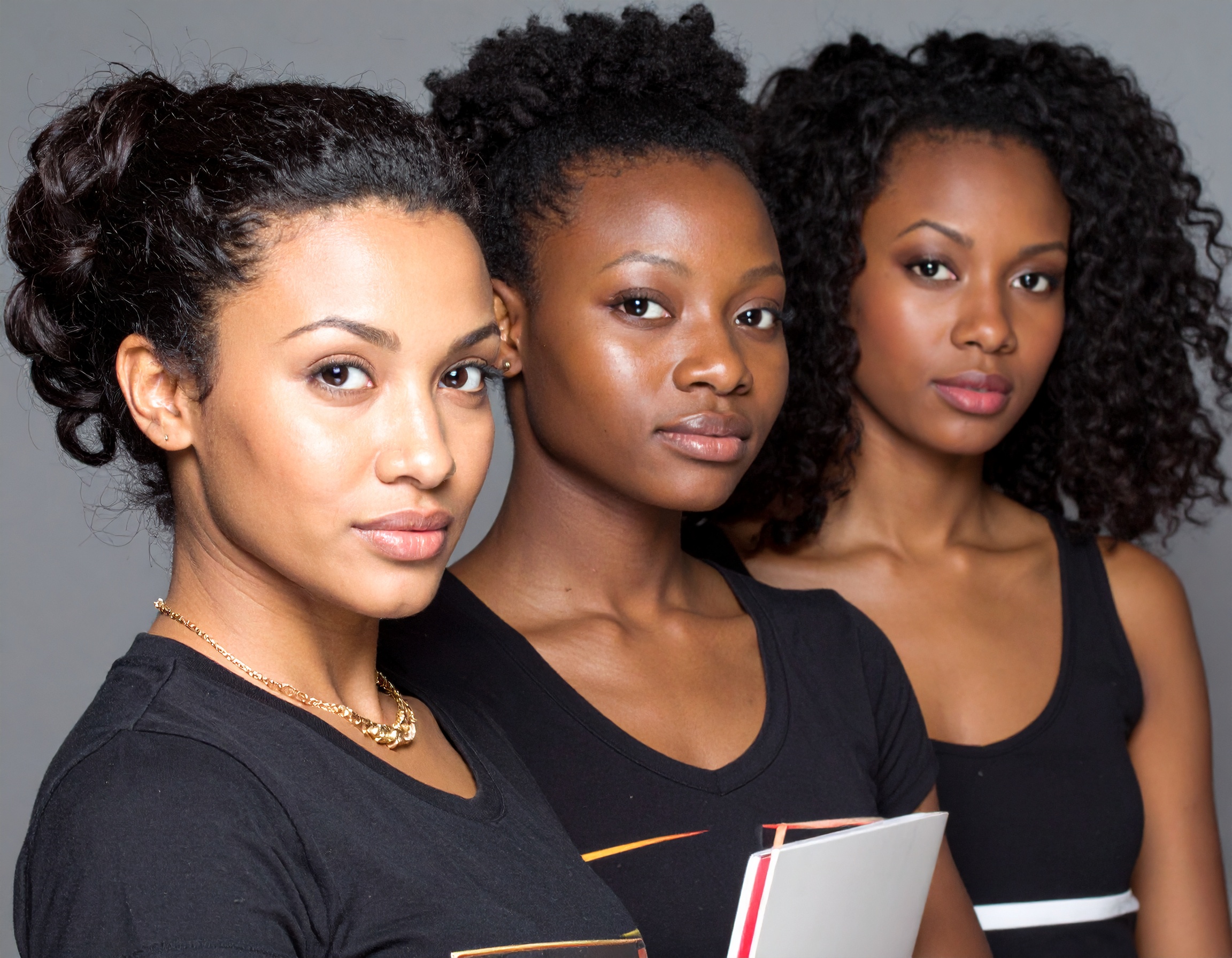 Three female students standing side-by-side